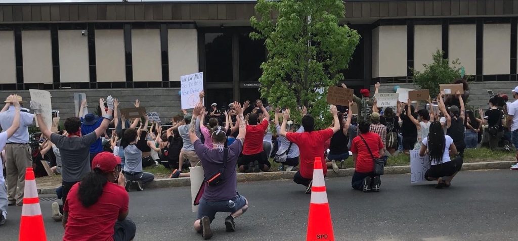 Protesters kneel at a Black Lives Matter event in Springfield